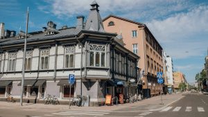 grey and white building in street corner