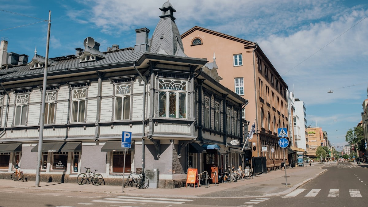 grey and white building in street corner